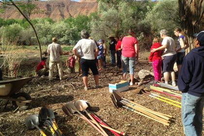 Piles of Shovels with People Standing By